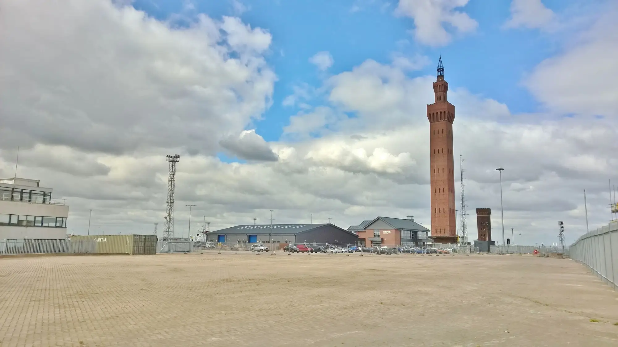 The Victorian Grimsby Dock Tower rising above the Royal Dock area of Grimsby beneath a dramatic cloudy sky