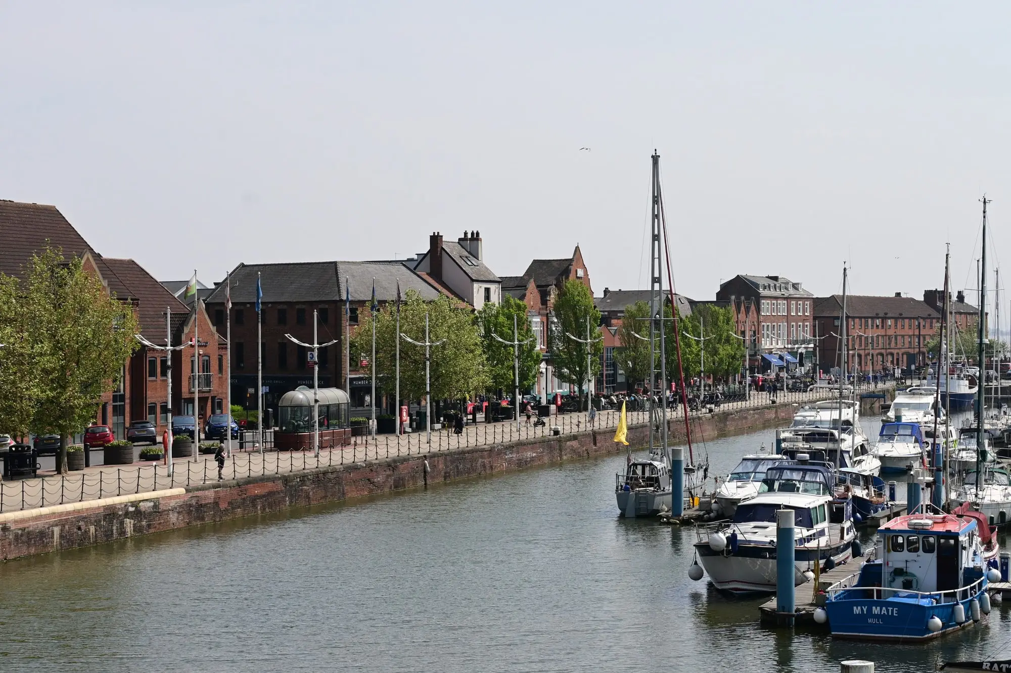 Hull Marina with yachts and motor boats moored along the pontoons and the historic warehouses of the waterfront behind