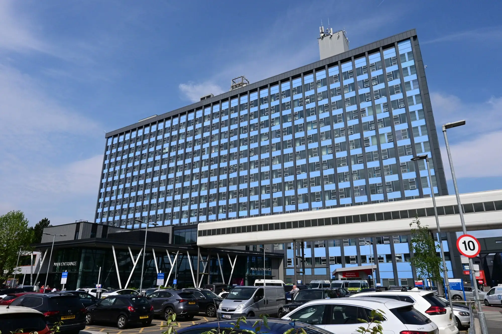 The tower block and new main entrance of Hull Royal Infirmary on Anlaby Road, Hull, under a blue sky