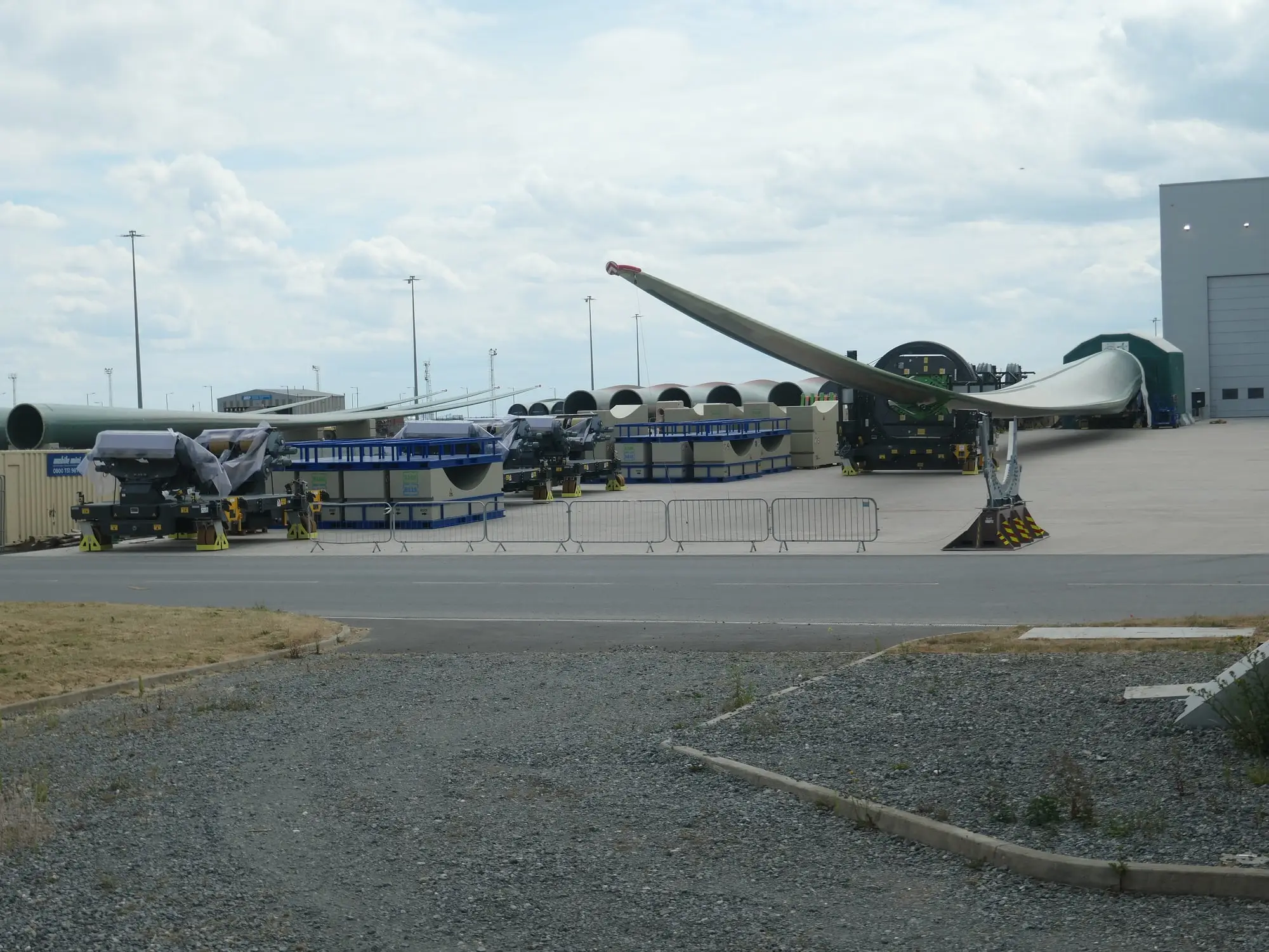 Wind turbine blades and root sections stored on transporters outside the Siemens Gamesa blade factory at Alexandra Dock, Hull